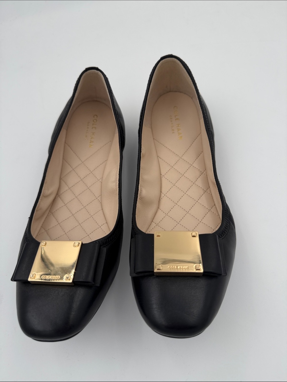 Like new Cole Haan Black Leather Ballet Flats with Gold Bow Accent